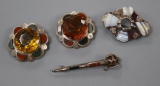 Four assorted Scottish hardstone brooches, sterling sword, two white metal mounted and one