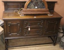 A 1920's Jacobean revival oak sideboard, W.150cm, D.52cm, H.96cm