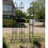 Four wrought iron garden rose frames, H.300cmCONDITION: All weathered, one has two bent post prongs,