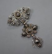 A continental pierced white and yellow metal, rose cut diamond set graduated three tier drop brooch,