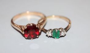 A yellow metal and plat, emerald and diamond three stone ring, (emerald chipped) size M, gross 1.8