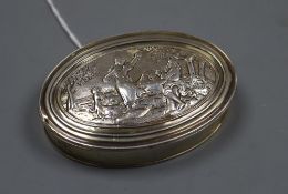 A 19th century continental embossed gilt white metal oval snuff box, unmarked, 75mm, 56 grams.