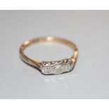 A 1930's 18ct and plat three stone diamond ring, size M, gross 1.7 grams.CONDITION: One stone has