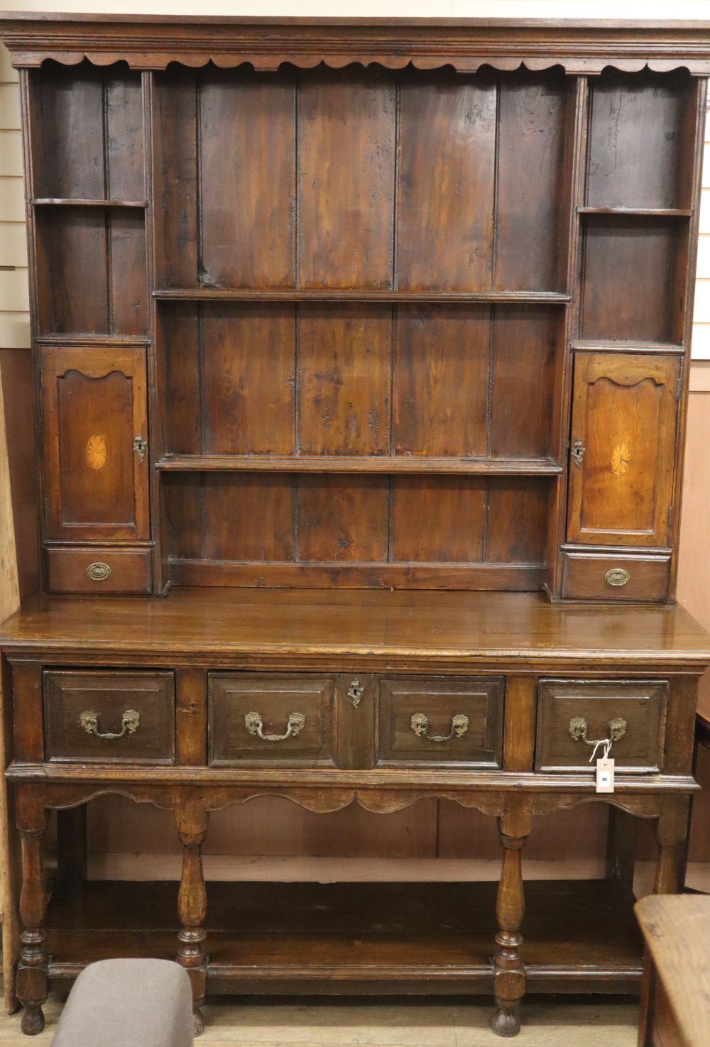 An oak dresser, 18th century and later W.150cm, D.53cm, H.212cm