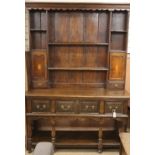 An oak dresser, 18th century and later W.150cm, D.53cm, H.212cm