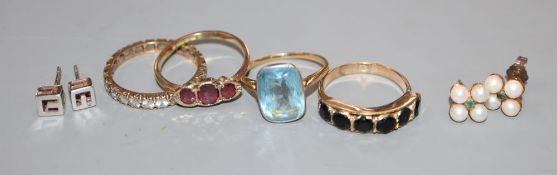 Three 9ct and gem set rings including three stone garnet, a yellow metal and gem set ring, a pair of