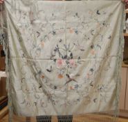 A late 19th century Chinese embroidered and fringed cover, decorated with flowers and butterflies on