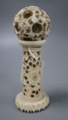 An ivory concentric puzzle ball on stand, overall height 15cm