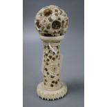 An ivory concentric puzzle ball on stand, overall height 15cm