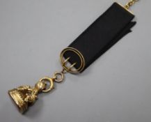 A Victorian yellow metal overlaid and carnelian set fob seal, with 9ct mounted ribbon sash with