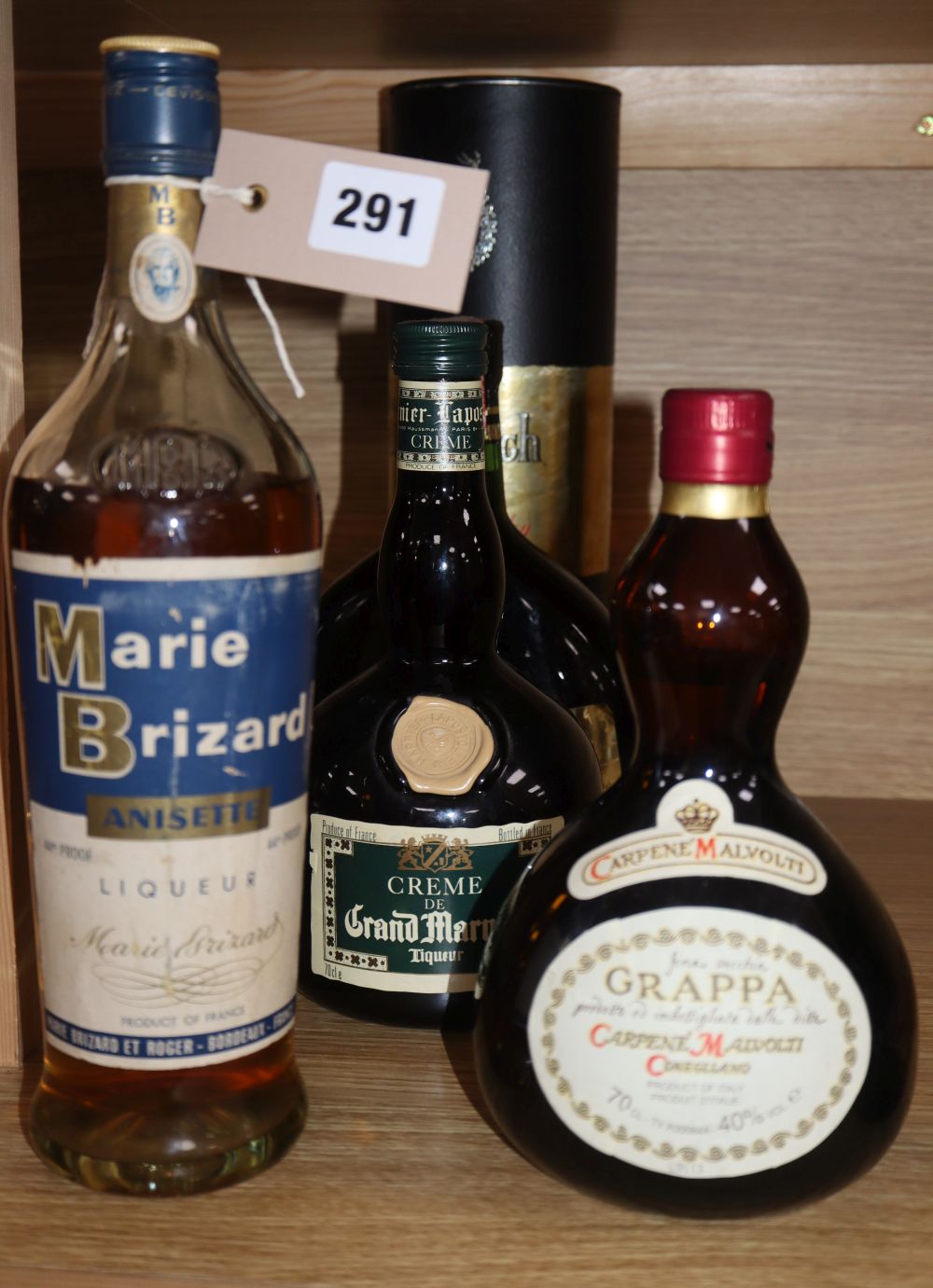 A bottle of Glenfiddich, a bottle of Grappa, a bottle of Whisky Almateo liqueur, a bottle of Grand