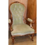 A Victorian deep-buttoned carved walnut open armchair