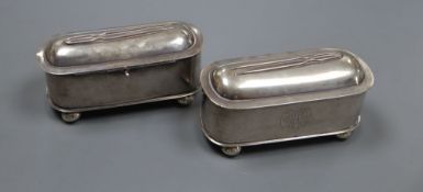 A pair of late 19th/early 20th century Chinese white metal oval pin boxes, on ball feet, by Tuck