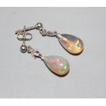 A pair of white metal, pear shaped opal and diamond set drop earrings, 25mm, gross 2.3 grams.
