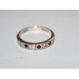 A modern 18ct white gold, sapphire and diamond set seven stone half hoop ring, size N, gross 3.7