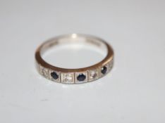 A modern 18ct white gold, sapphire and diamond set seven stone half hoop ring, size N, gross 3.7
