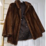 A brown mink jacket with embroidered lining