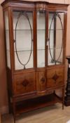 A Sheraton revival inlaid mahogany bow front display cabinet, W.110cm, D.50cm, H.198cmCONDITION: