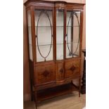 A Sheraton revival inlaid mahogany bow front display cabinet, W.110cm, D.50cm, H.198cmCONDITION: