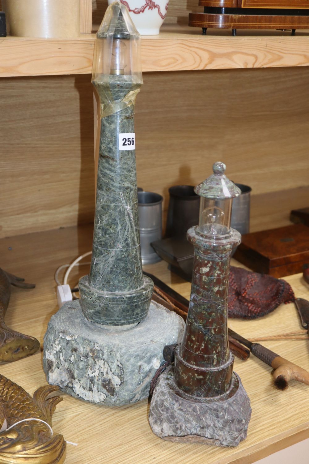 A large Cornish serpentine lighthouse lamp and a similar smaller,