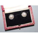 A pair of white metal (stamped silver) and cultured pearl set earclips, in a bright cut setting,