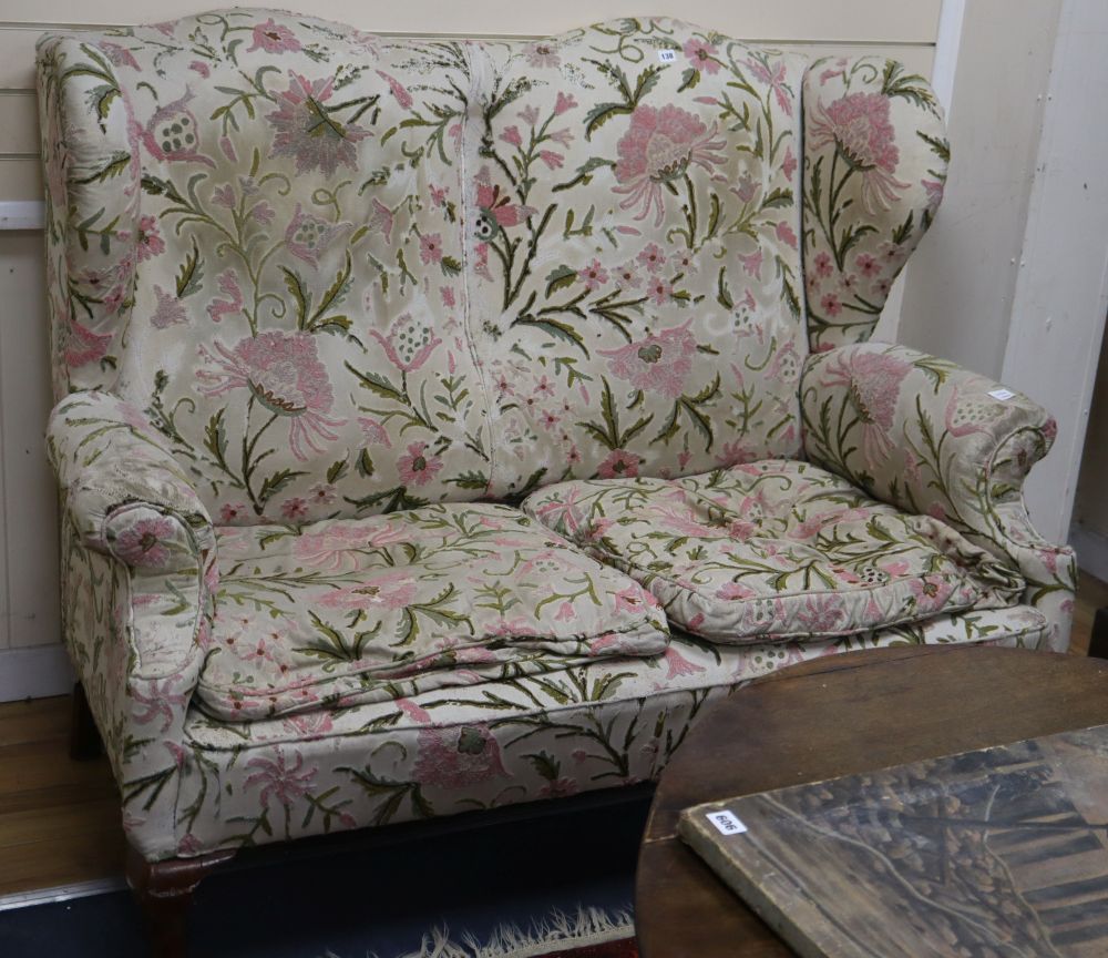 A George III wing back settee, with crewel work upholstery, L.148cm, D.80cm, H.118cm