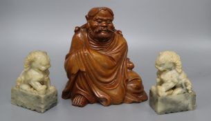 A Japanese rootwood carving of a seated elder, inset eyes and teeth and a pair of Chinese