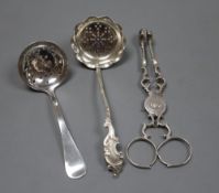 A pair of Georgian silver sugar nips(repair), 12cm and two silver sugar sifter spoons, gross 64