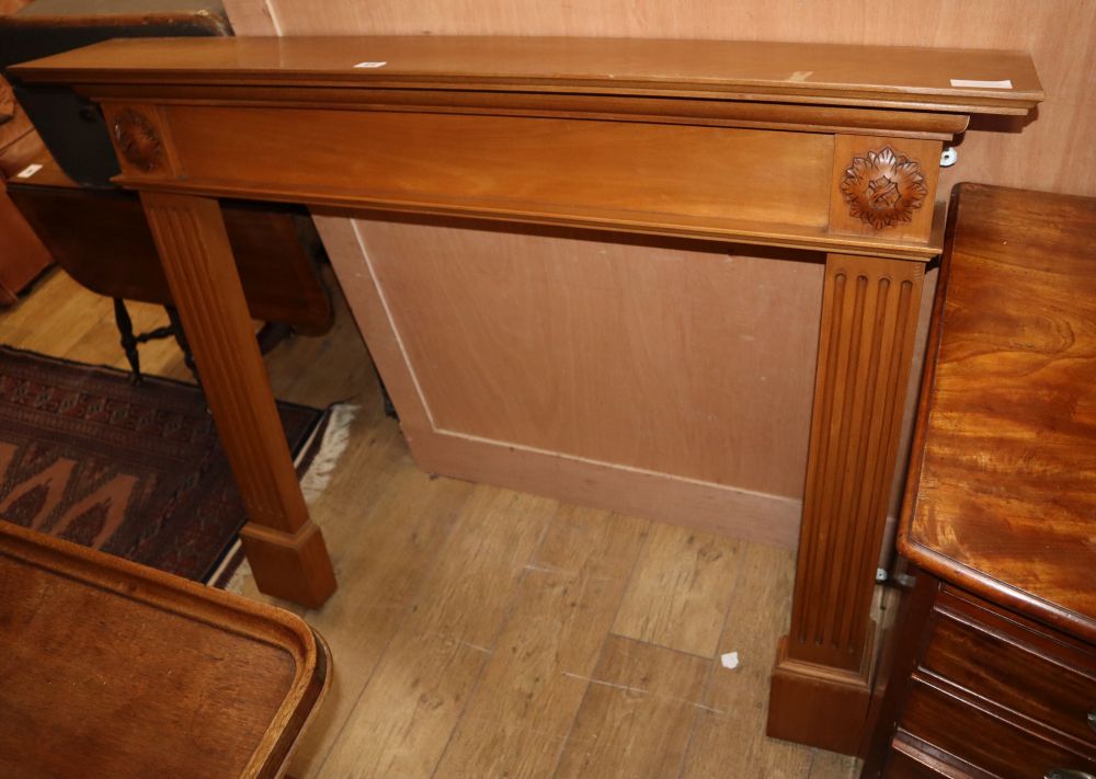 A reproduction pine fire surround, W.125cm H.102cm