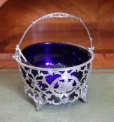A late Victorian pierced silver sugar basket with blue glass liner, E.S. Barnsley & Co,