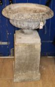 A reconstituted stone Campana garden urn on square-shaped plinth, H.94cmCONDITION: Nice weathered