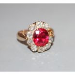An early-mid 20th century yellow metal, red doublet and diamond set oval cluster ring, size K, gross