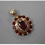 A modern 585 and garnet set oval cluster pendant, 16mm, gross 3.6 grams.CONDITION: Overall good
