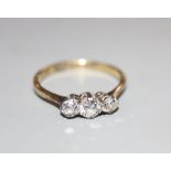A mid 20th century 18ct and plat, three stone diamond ring, size N, gross 2.3 grams.CONDITION: