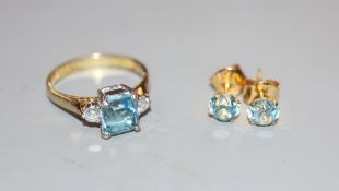 A modern 14k, aquamarine and diamond set three stone ring, size P, gross 3.5 grams and a pair of 14k