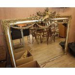 A gilt-framed rectangular overmantel mirror with bird and flambeau surmount and swag decoration, W.
