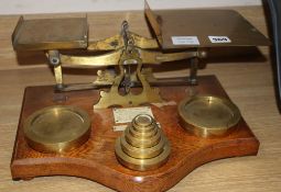 A set of large Edwardian oak and brass postal scales, base length 38cm