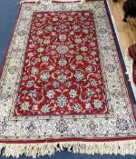 A Tabriz red ground rug, 185 x 120cm