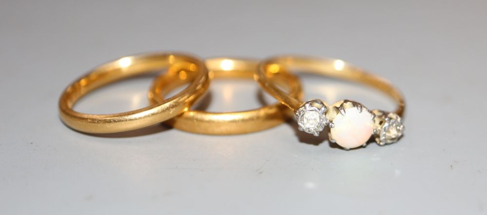 Two 22ct gold wedding bands, 6.6 grams and a yellow metal, white opal and diamond set three stone