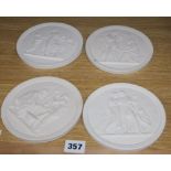 A set of four classical plaster wall plaques, diameter 13.5cm