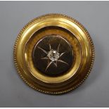 A Victorian yellow metal and diamond set circular brooch, with glazed back, 32mm, gross 10.3 grams.