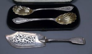 A cased pair of fancy silver serving spoons by George Adams, London, 1857 and a silver fiddle