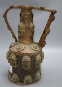 A Middle Eastern copper pot, decorated with classical ladies and lions faces with turquoise beaded