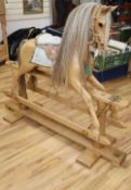 A carved natural oak rocking horse by Stevenson Bros, No 1075, 1992, L.140cm H.122cmCONDITION: The