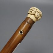 A late 19th century ivory 'mask' handled walking cane, overall length 92cm