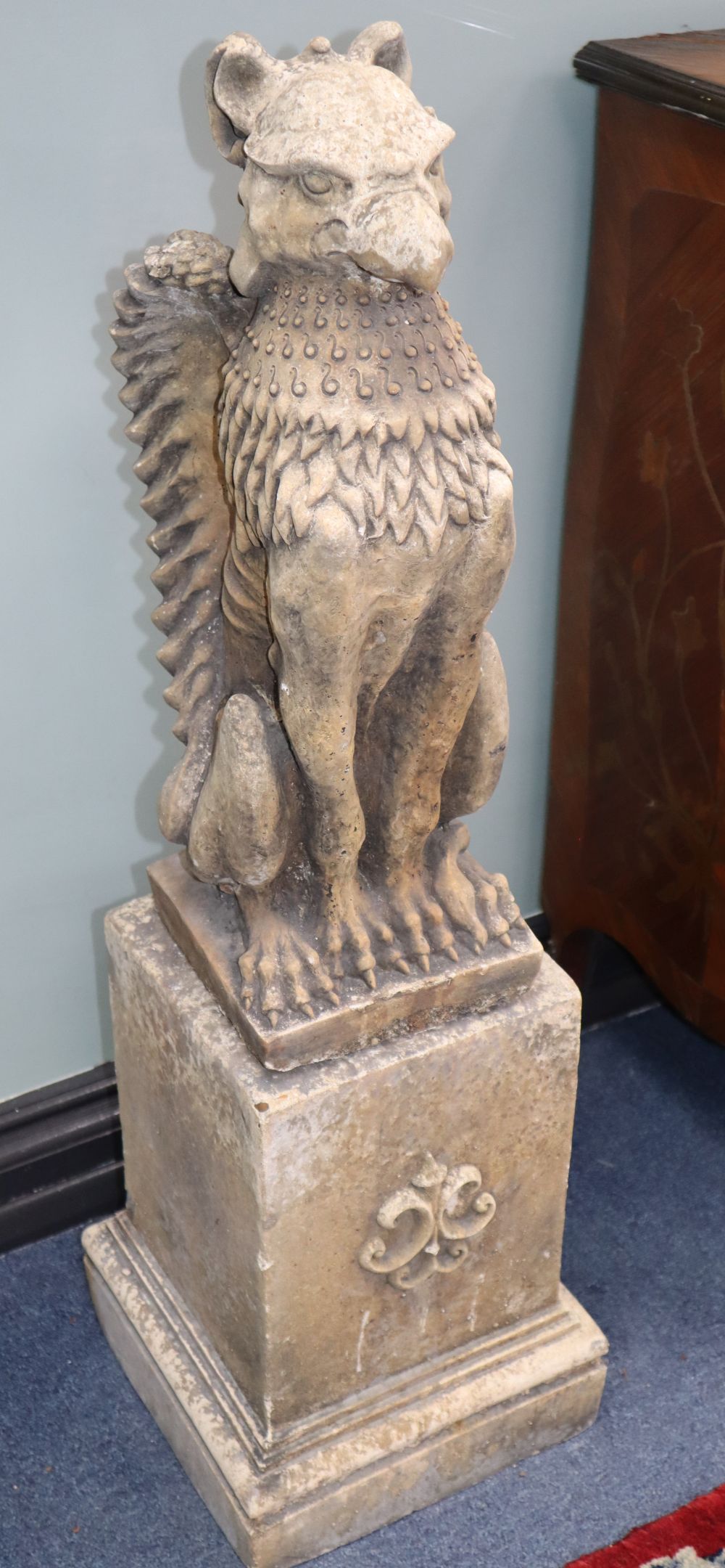 A pair of composition griffins and pedestals, H.94cm