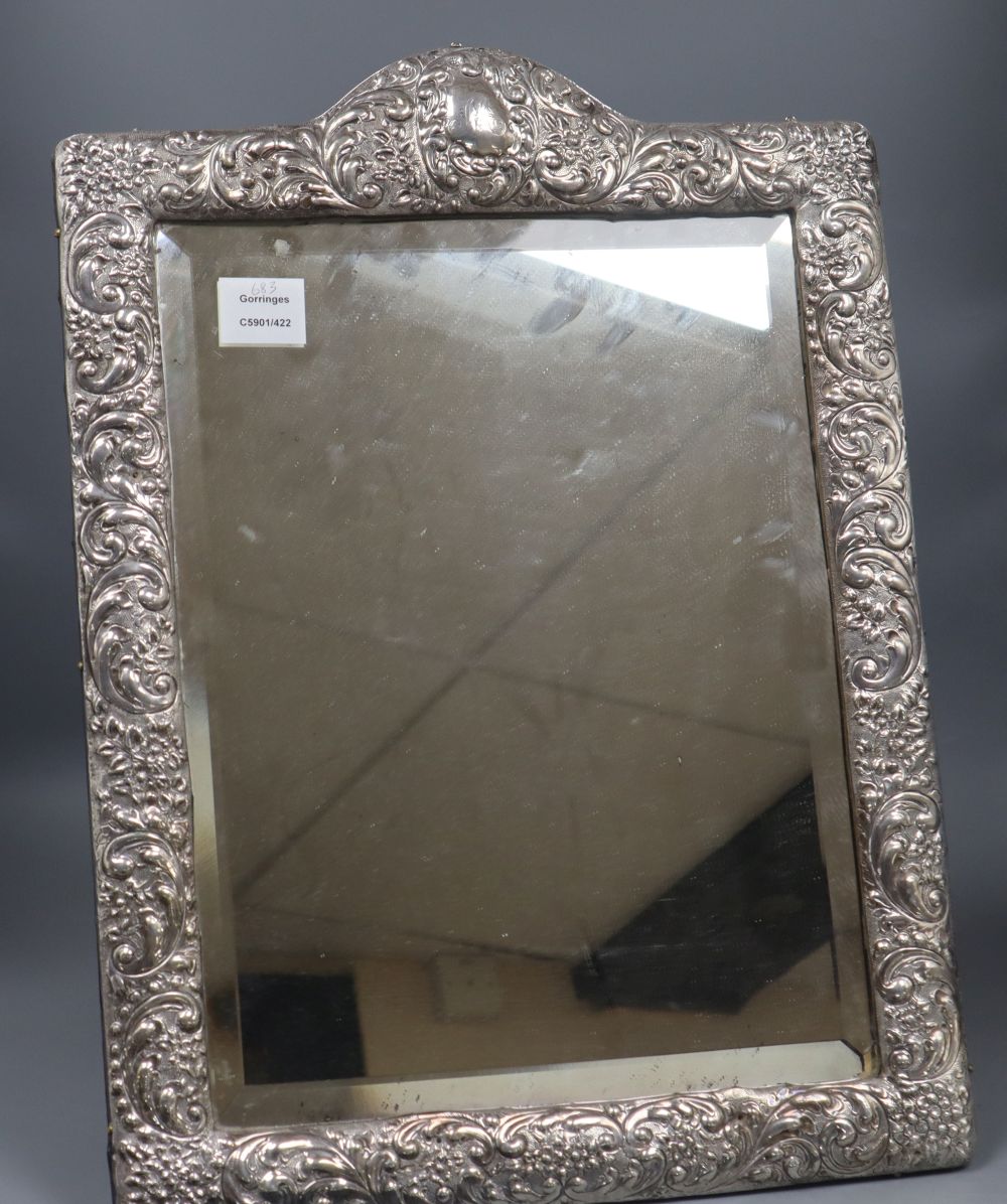 An Edwardian repousse silver mounted easel mirror by A & J Zimmerman, Birmingham, 1904, 55.6cm.