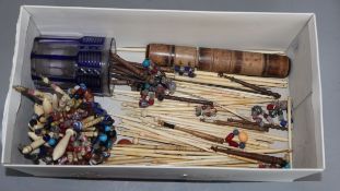 A collection of 19th century glass beaded bone or treen lace bobbins, and bone crochet hooks and