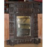 A carved oak wall mirror, W74cm, H.90cm