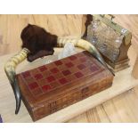 A three bottle tantalus (no key), mounted horns and a leather games box